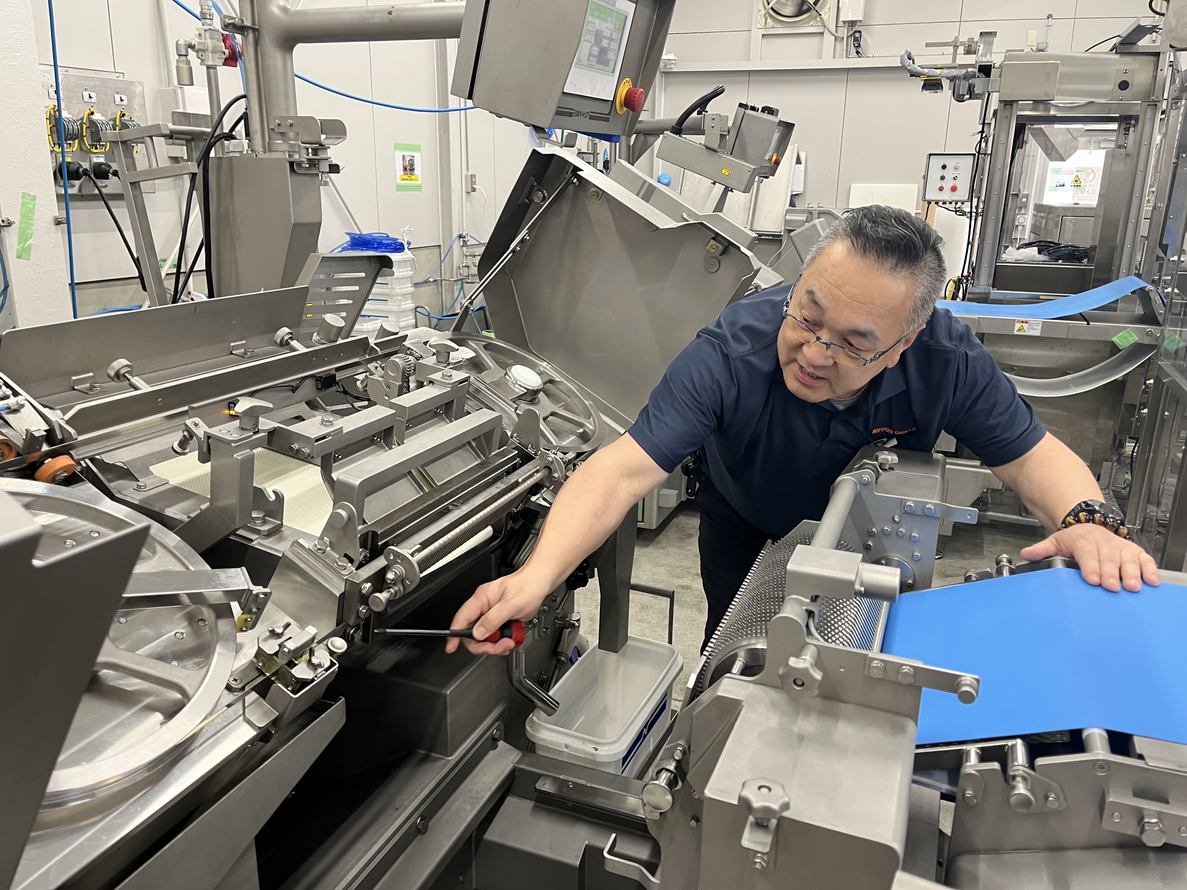 Close-up of the band knife and blade-access area on an NCI slicer
